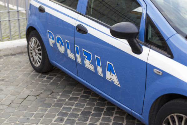 Close up of an Italian blue police car with inscription Polizia (police) in Italian